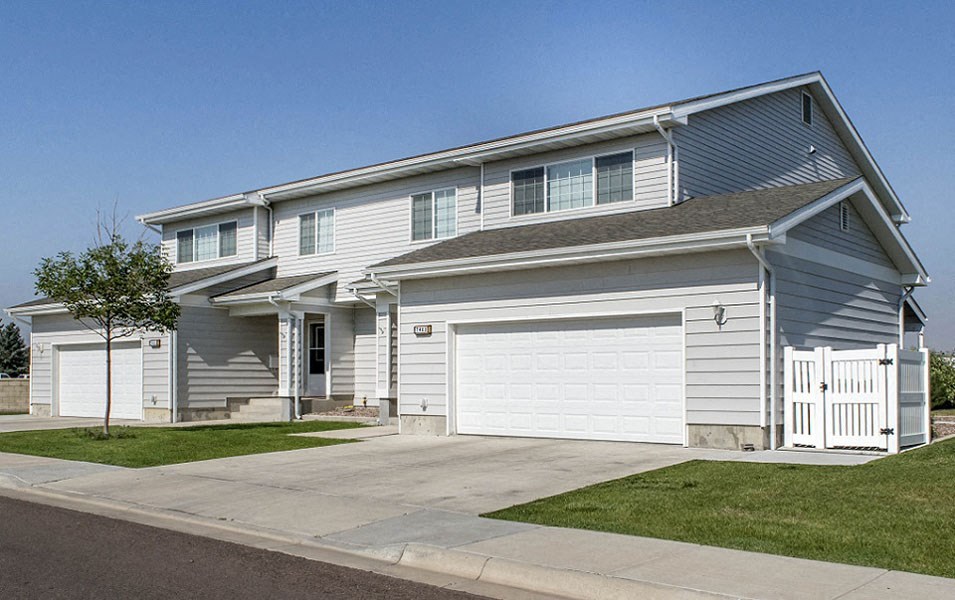 a blue and white house with a white garage door