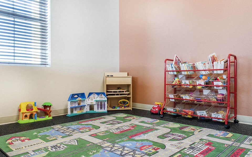 a childs play room with toys and a rolling cart