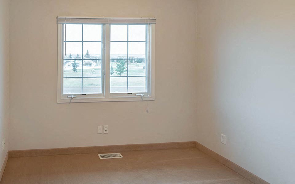 an empty room with a window and a