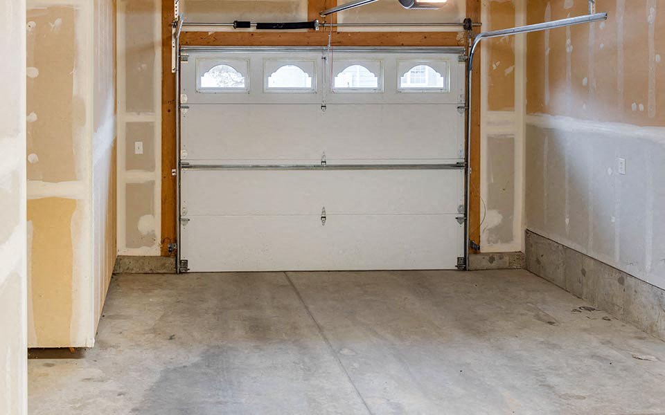 an empty garage with a white door