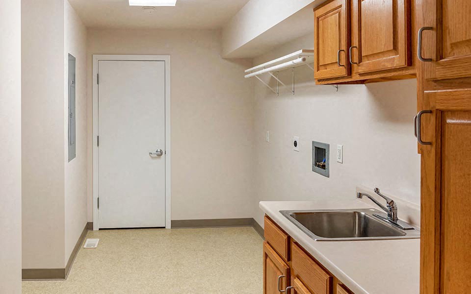 a kitchen with a sink and wooden cabinets