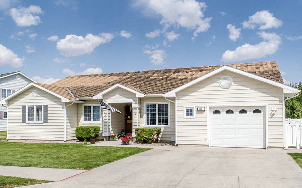 a white house with a garage and a driveway