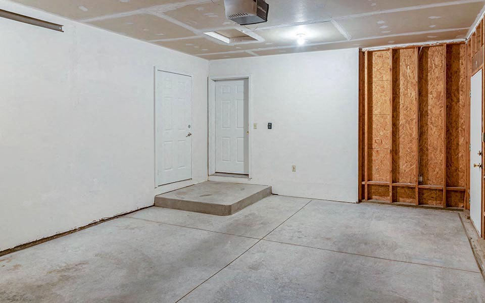 a room with white walls and a door
