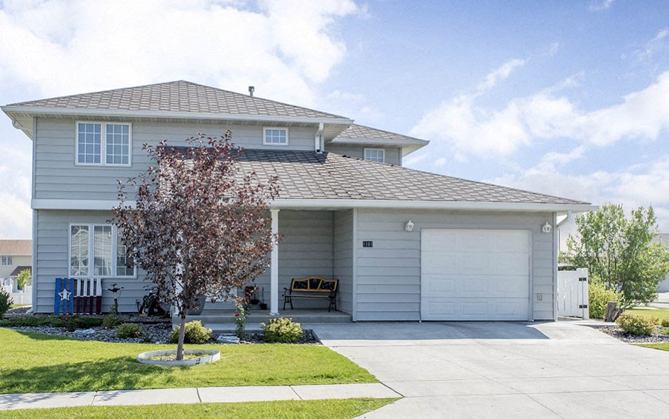 a white house with a driveway and a garage door