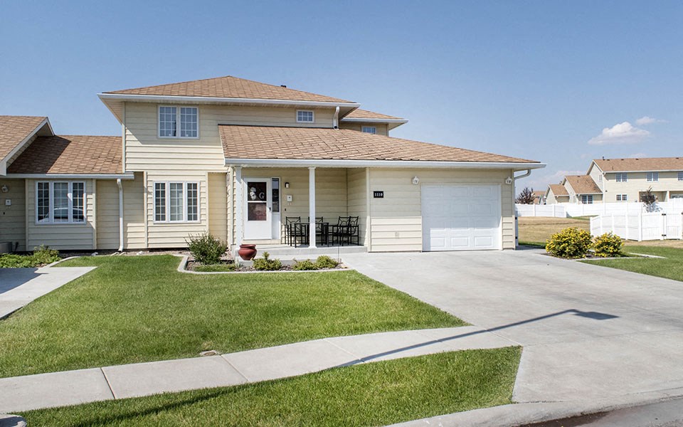 a white house with a driveway in front of it