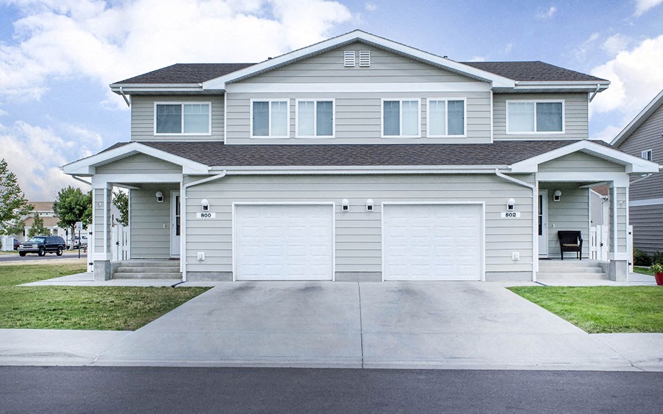 a white house with a white garage door