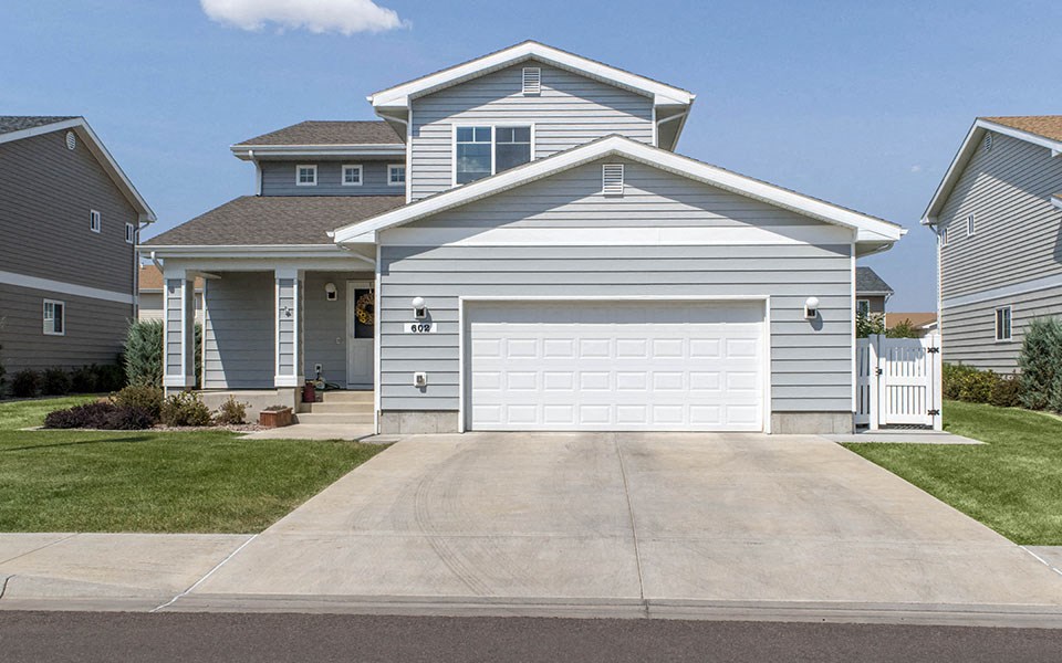 a blue house with a white garage door