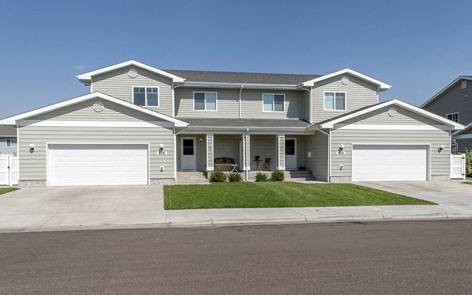 a white house with two garage doors