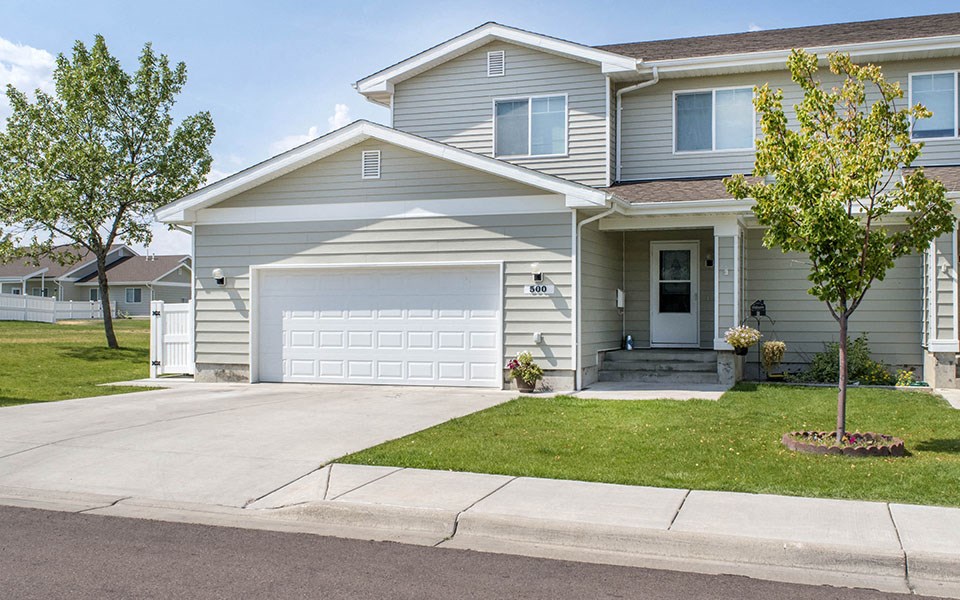 a blue house with a white garage door