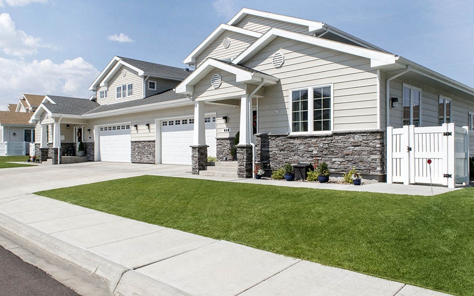 a white house with a lawn in front of it