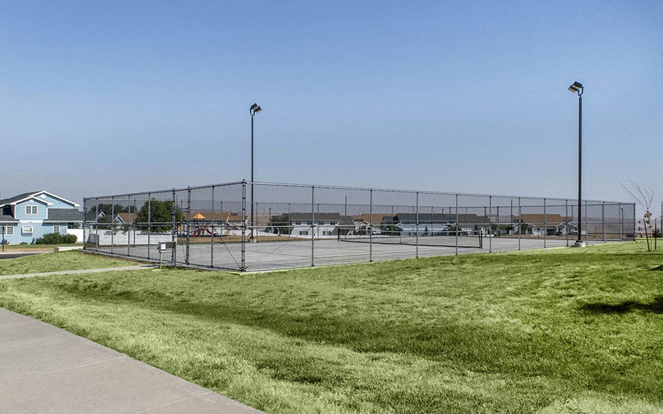 a tennis court with a chain link fence around it