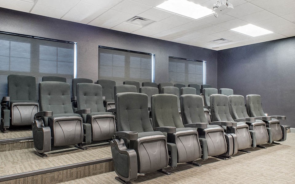 a room filled with empty chairs in an empty auditorium