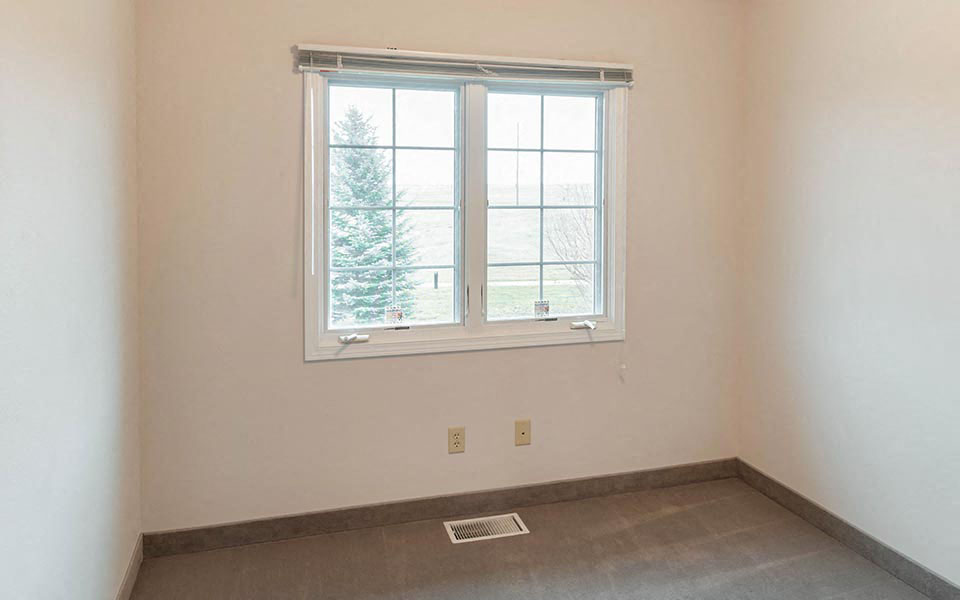 an empty room with a window and a