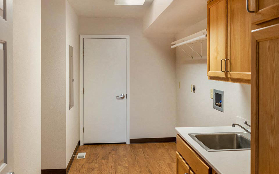 a kitchen with a sink and a white door