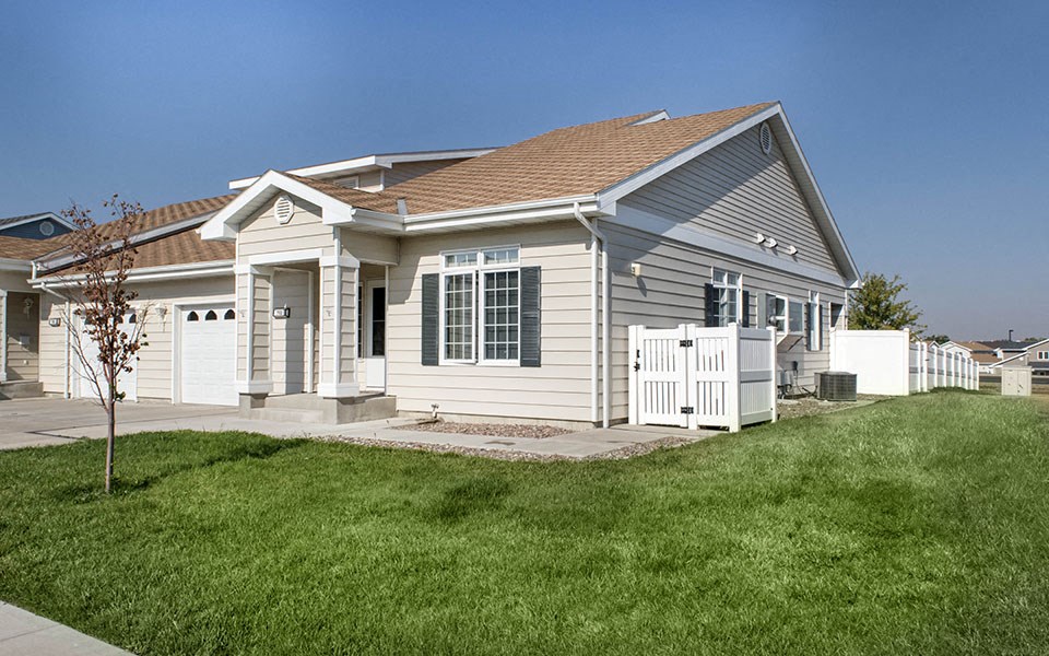 a white house with a yard and a white fence