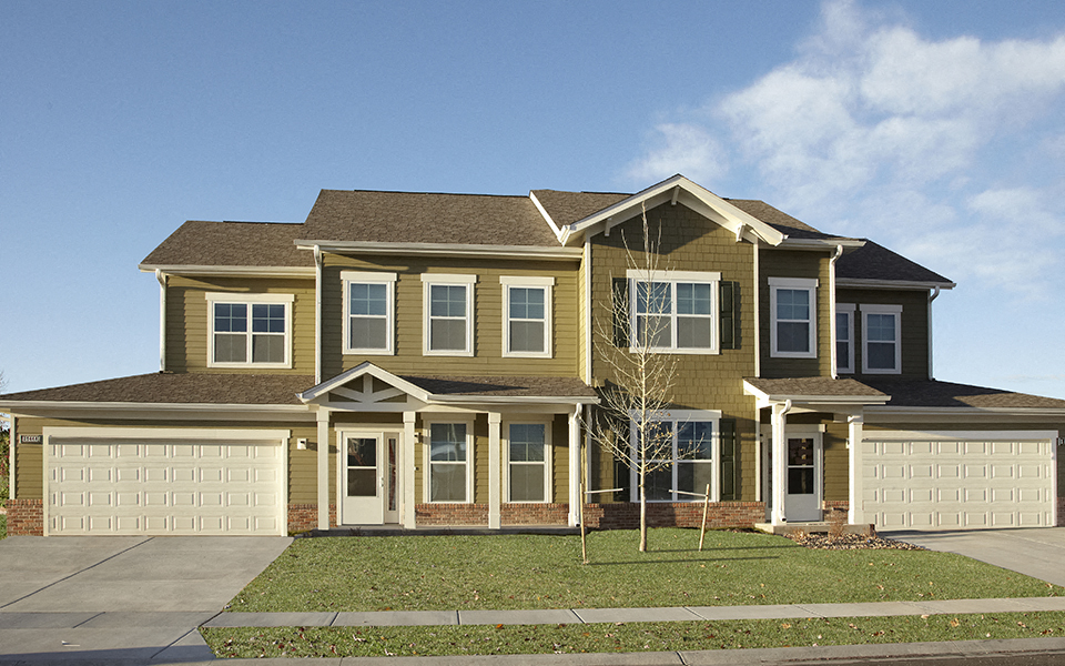 a large house with a lawn and a sidewalk