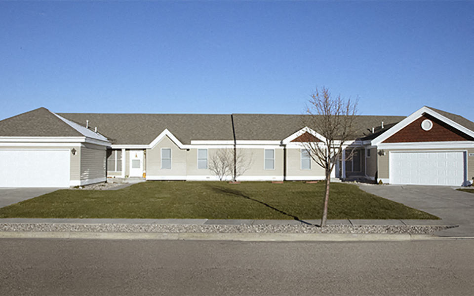 a house with a lawn in front of a street
