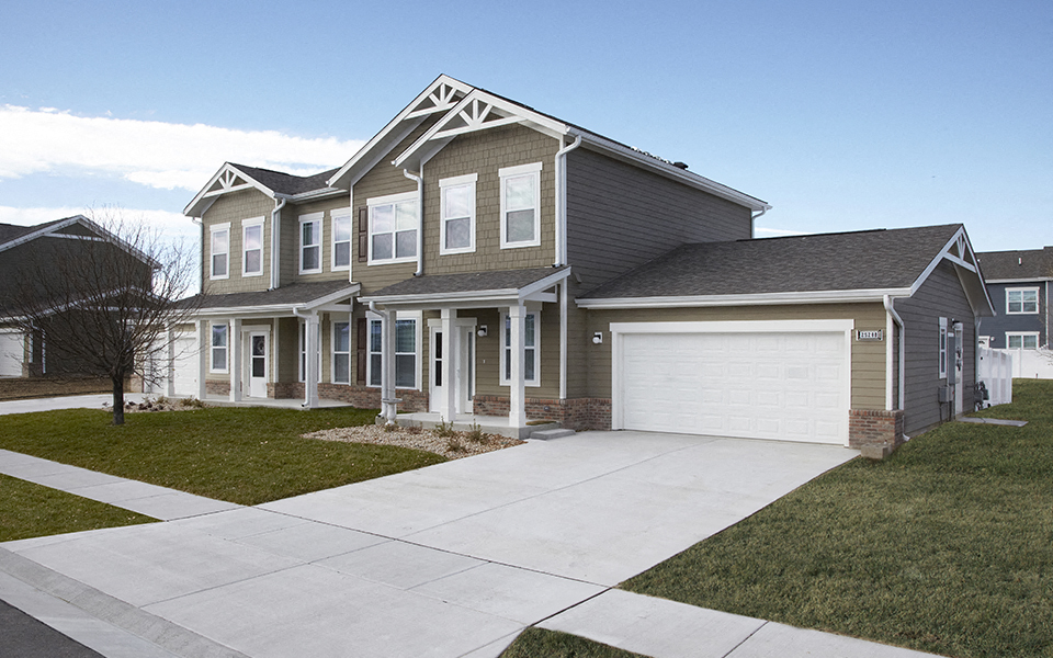 a house with a white driveway in front of it