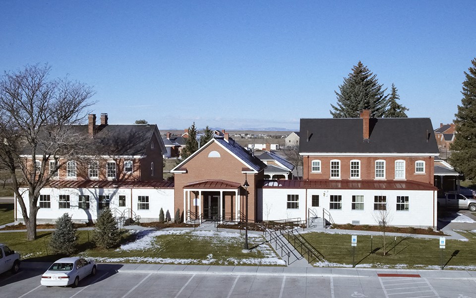 an aerial view of a building with a snow covered yard