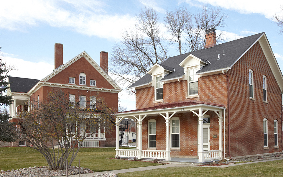 two houses on the side of a lawn