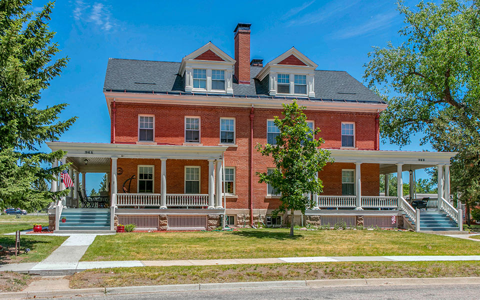 a large brick house with a lawn in front of it