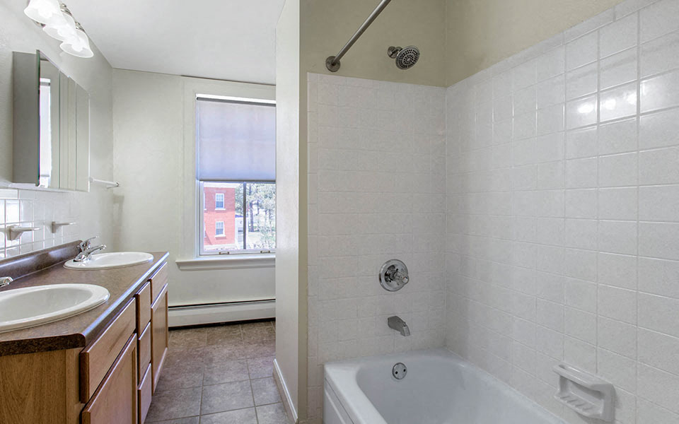 a bathroom with a tub and a sink and a shower