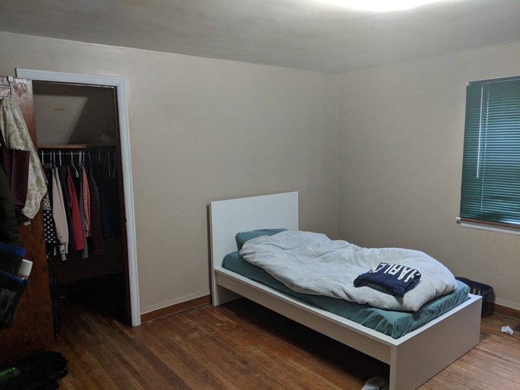 a bedroom with a bed and a closet