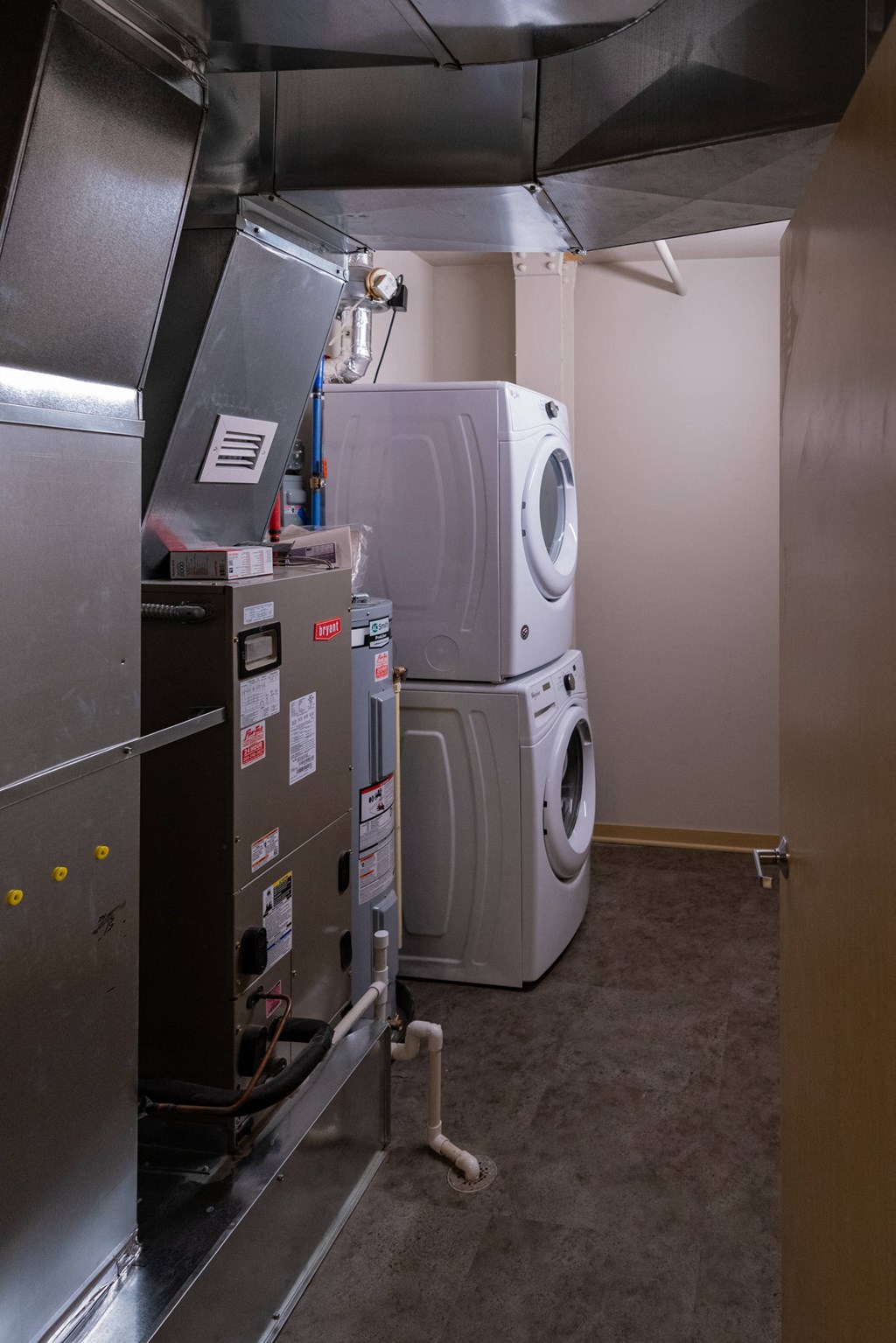 the laundry room has two washers and a dryer in it