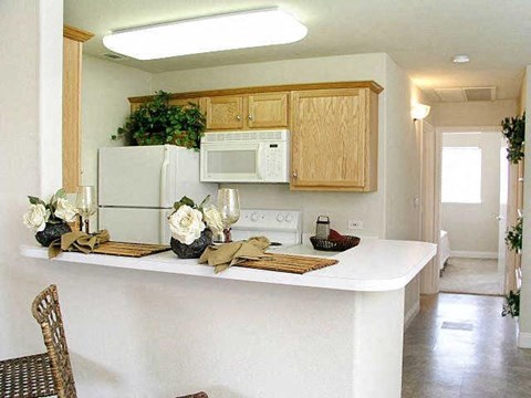 a kitchen with a white counter top and a microwave