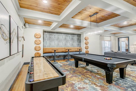 a game room with two shuffleboards and a pool table