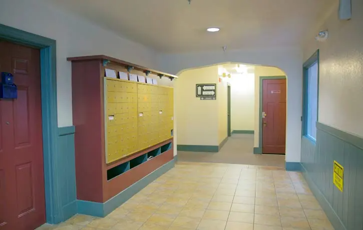 a hallway with lockers and doors in a building