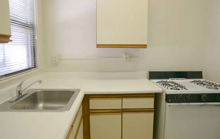 a kitchen with a sink and a stove and a window