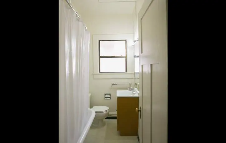 a bathroom with a toilet and a sink and a window