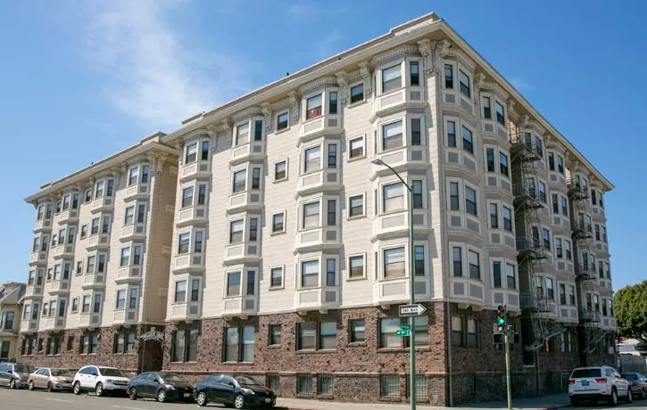 a large building with cars parked in front of it