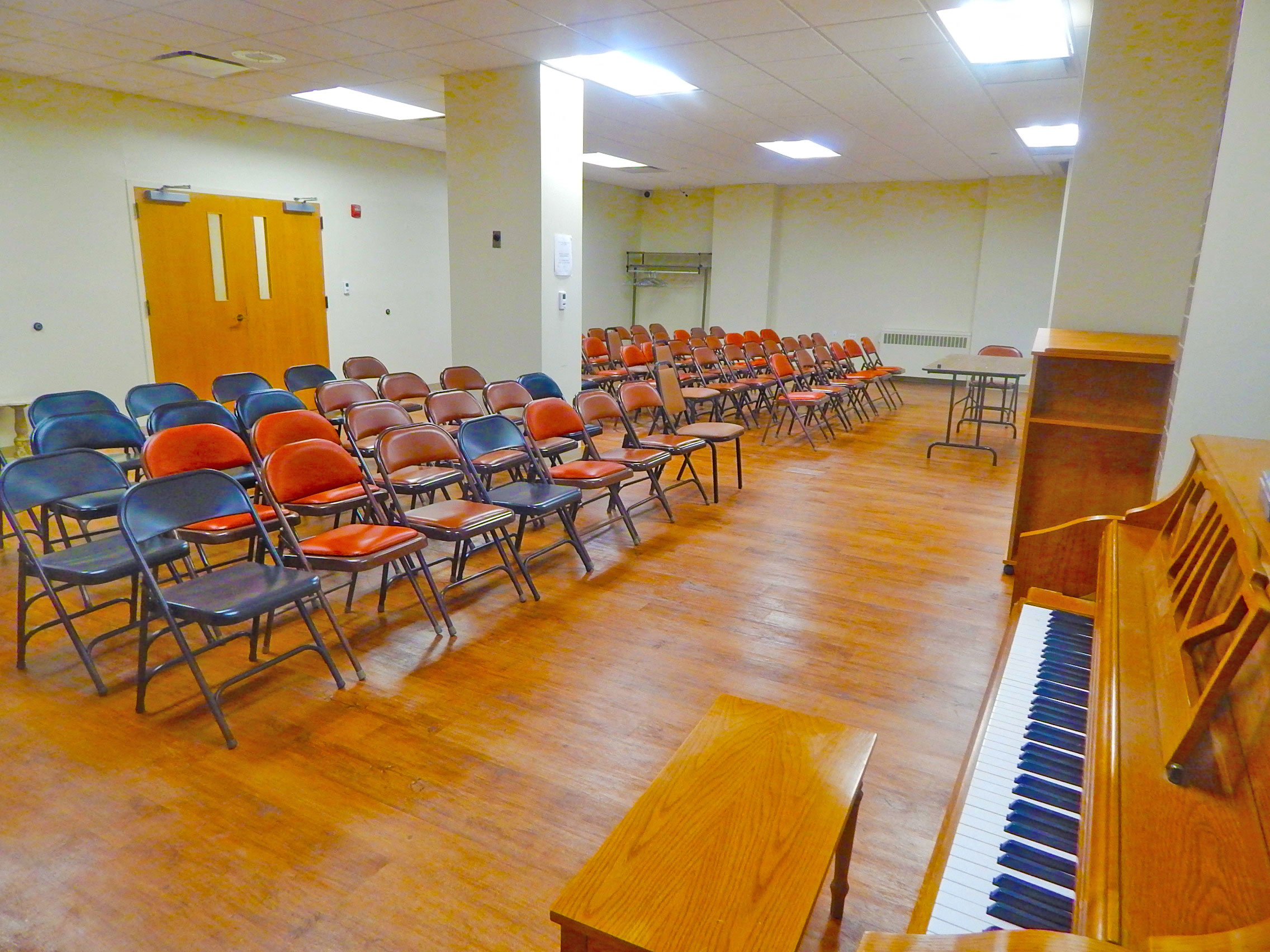 a large room filled with chairs and a piano