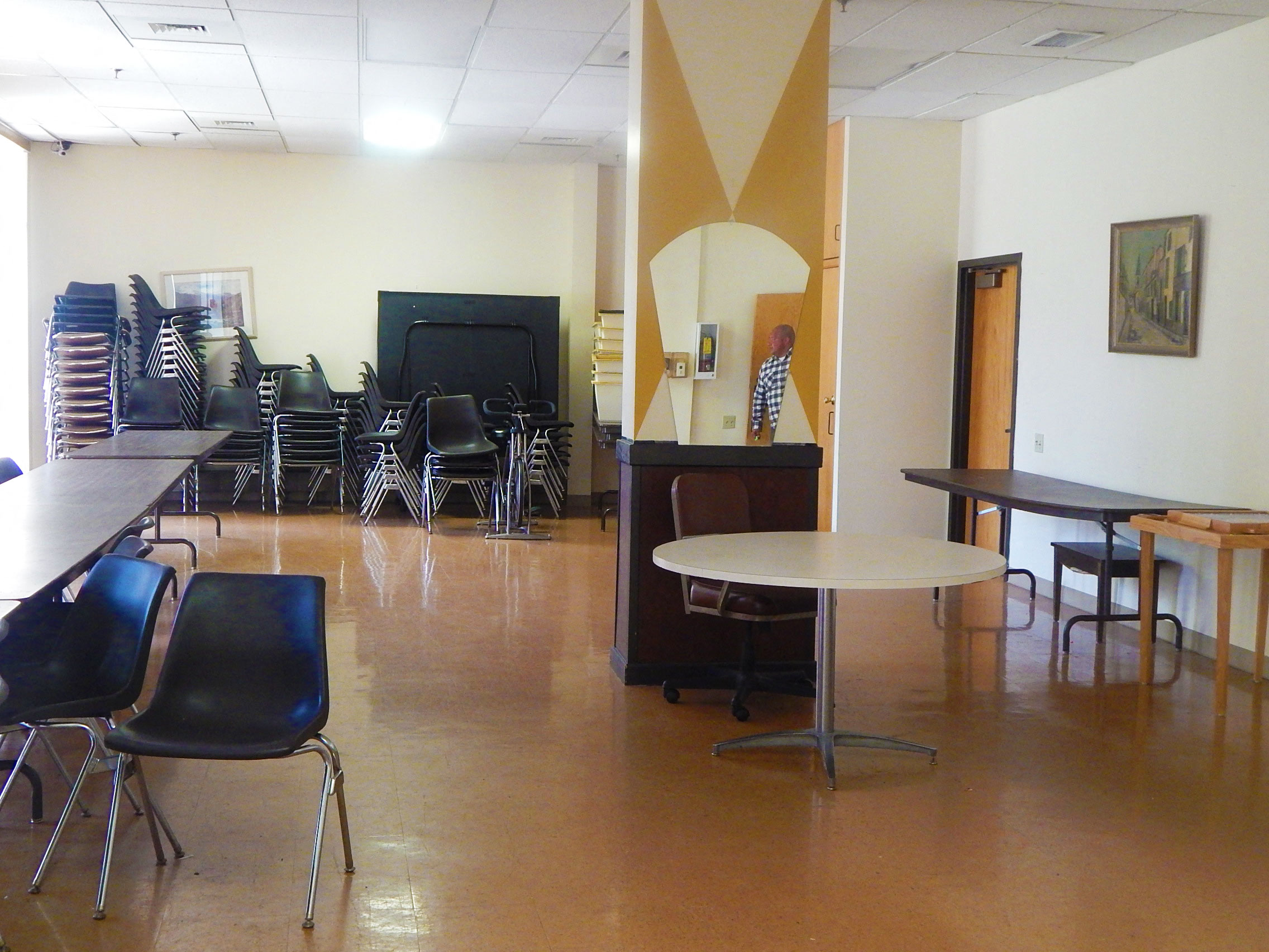 a dining room with tables and chairs and a piano