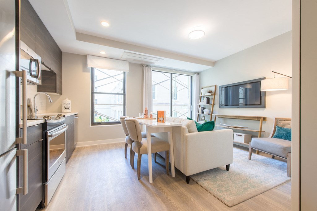 a kitchen and living room with a table and chairs