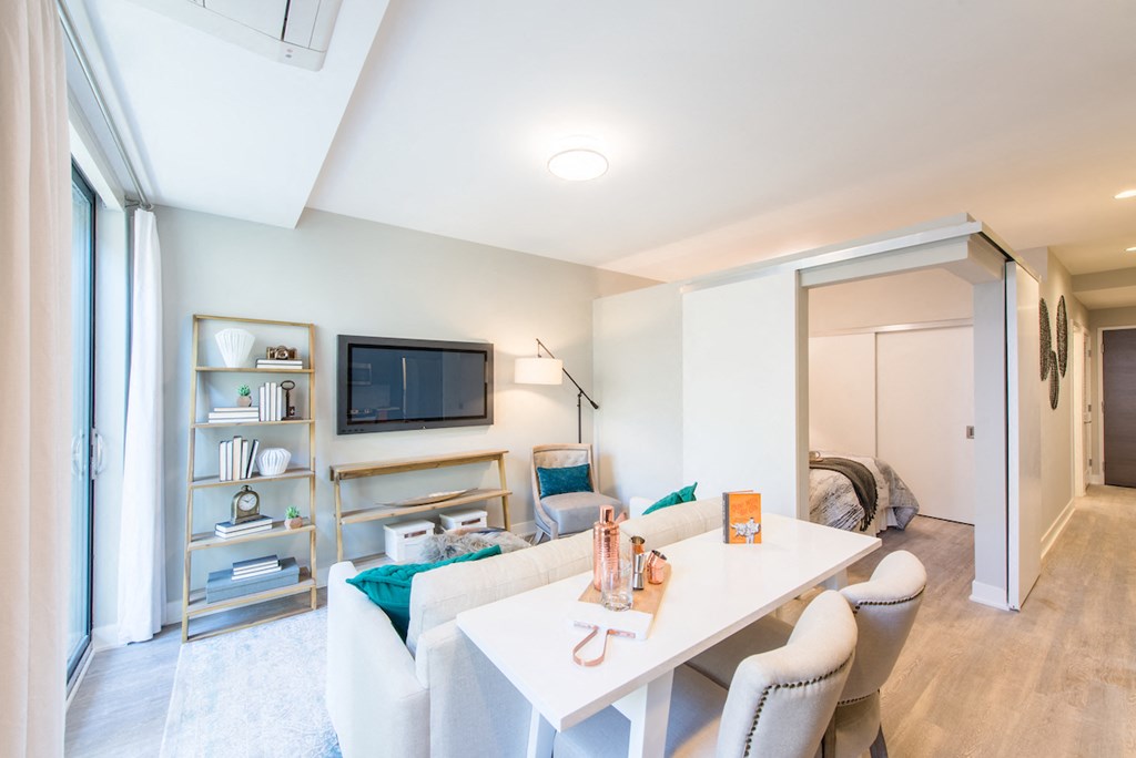a living room with a white table and a tv