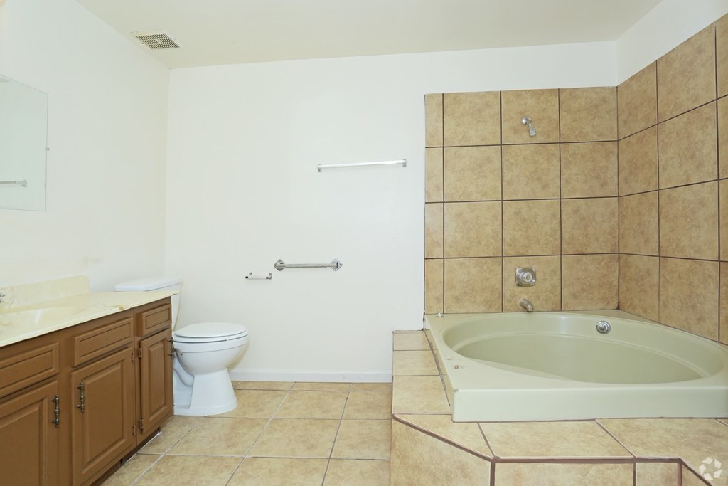 A bathroom with a toilet, sink, and bathtub.