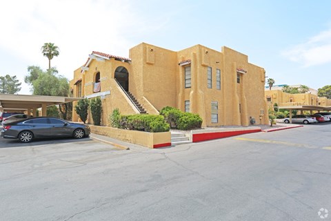 A building with a car parked in front of it.