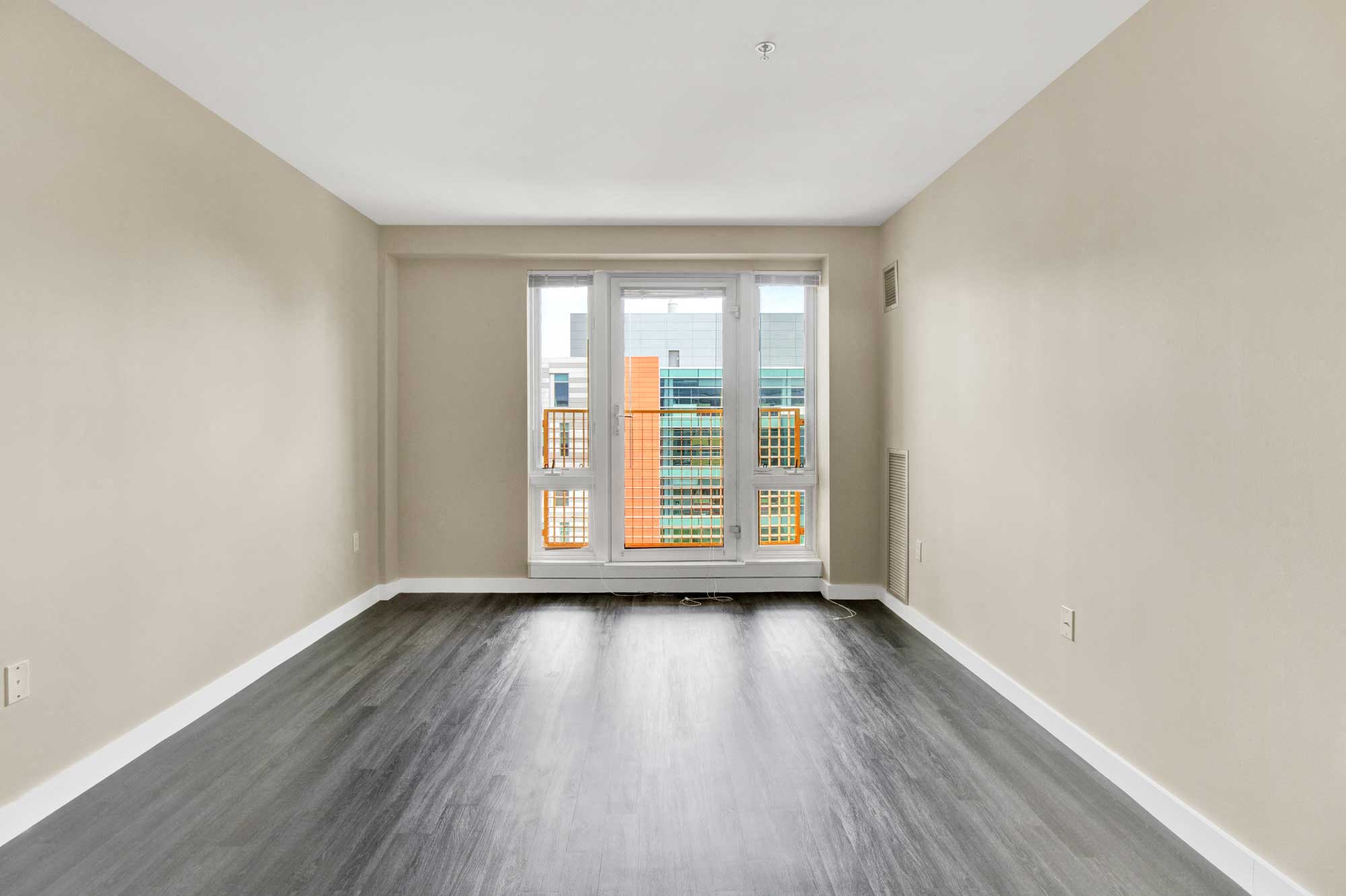 Living room featuring modern plank flooring and oversize windows