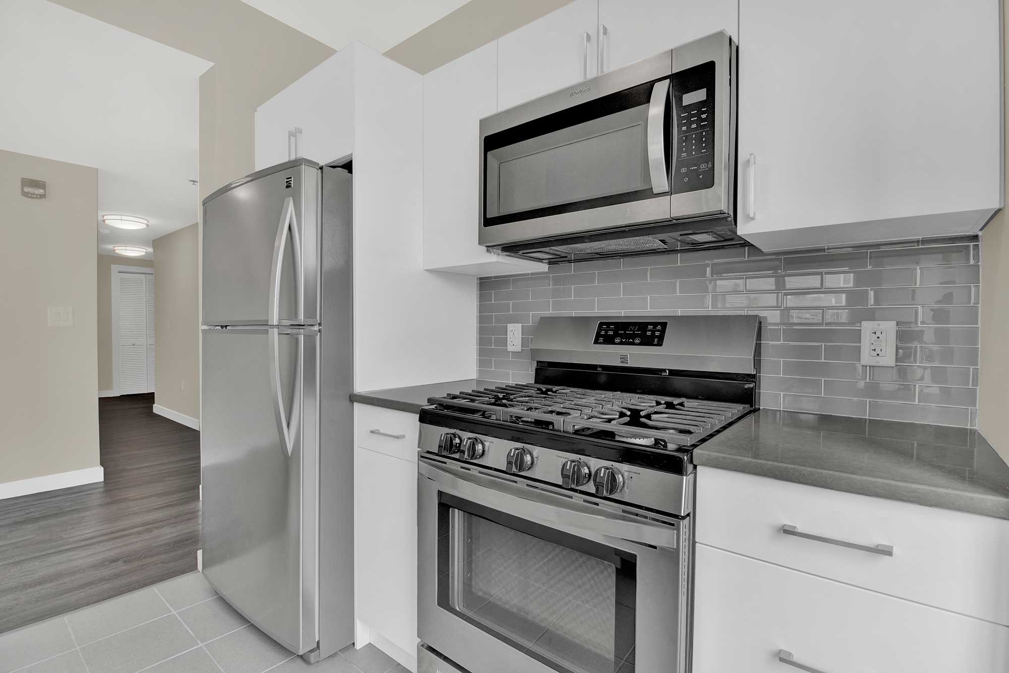 Kitchen features modern design and stainless steel appliances