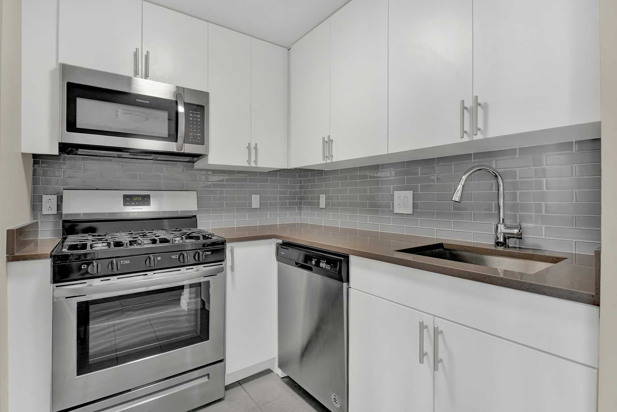 Kendall Crossing modern kitchen design with tile backsplash