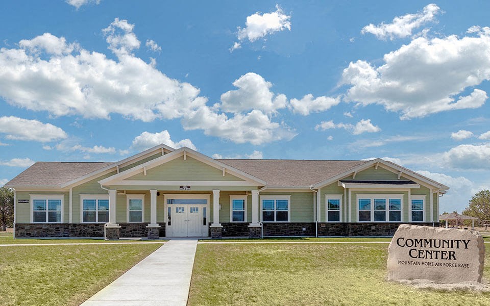 a community center building with a sign in front of it