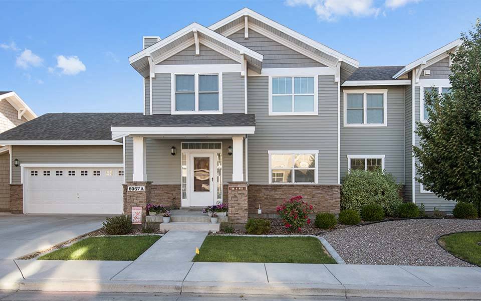 a gray house with a white garage door
