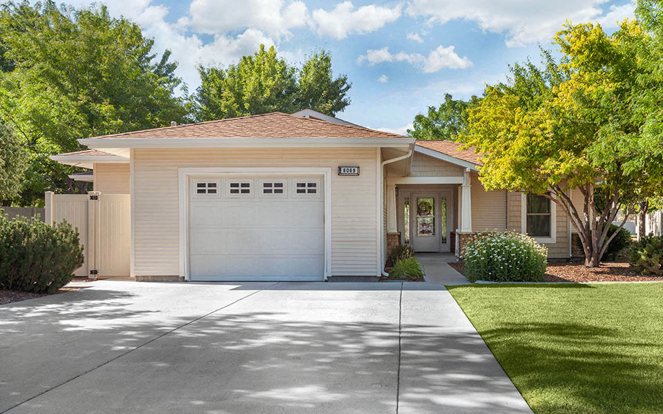 a white house with a driveway and a garage door