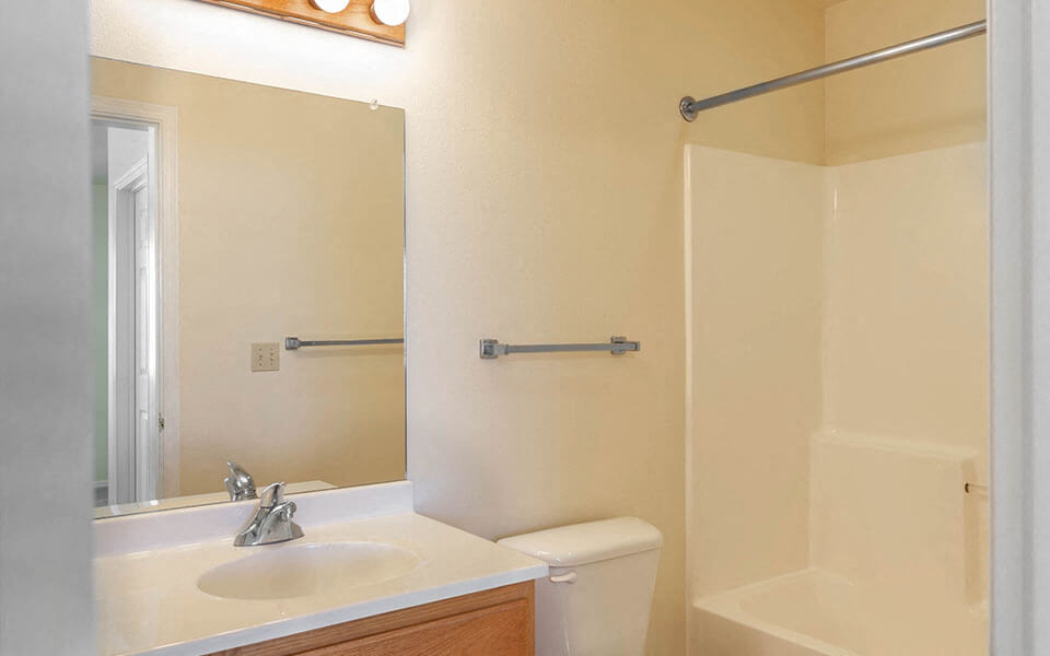 a bathroom with a sink toilet and a mirror