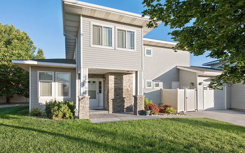 a white house with a sidewalk in front of it