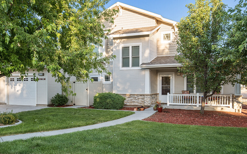 a white house with a sidewalk in front of it
