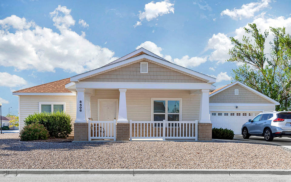 a white house with a car parked in front of it